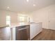 Bright kitchen featuring stainless steel appliances, white cabinets, an island, and an open floor plan at 1366 Foxtail Ln, Greenwood, IN 46143