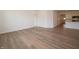 Open-concept living area with wood-look floors, neutral walls, and access to the kitchen area, ideal for entertaining at 1366 Foxtail Ln, Greenwood, IN 46143