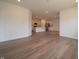 Bright living area featuring wood-look flooring, recessed lights, and an open layout connected to the modern kitchen at 1366 Foxtail Ln, Greenwood, IN 46143