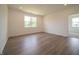 Spacious living room with recessed lighting, wood-look flooring, and natural light creating a bright living space at 1366 Foxtail Ln, Greenwood, IN 46143