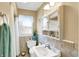 Compact bathroom with tiled walls, window, and decorative accents at 145 W Old South St, Bargersville, IN 46106