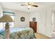 Comfortable bedroom with ceiling fan, wooden dresser and bright natural light at 145 W Old South St, Bargersville, IN 46106