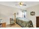 Comfortable bedroom with a ceiling fan, window, and a cozy chair, creating a welcoming atmosphere at 145 W Old South St, Bargersville, IN 46106