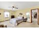 Cozy bedroom with a ceiling fan, window, and comfortable bedding, creating a relaxing space at 145 W Old South St, Bargersville, IN 46106