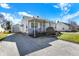 Charming one-story home with a well-manicured lawn, driveway, and detached garage under a beautiful sky at 145 W Old South St, Bargersville, IN 46106