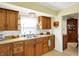 Practical kitchen with warm wood cabinetry and natural light. adjacent to dining area at 145 W Old South St, Bargersville, IN 46106
