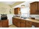 Functional kitchen with warm wood cabinets, stainless steel sink, and bright lighting at 145 W Old South St, Bargersville, IN 46106
