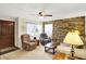 Cozy living room with natural light, comfortable seating, and unique brick accent wall at 145 W Old South St, Bargersville, IN 46106