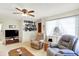 Cozy living room with natural light, comfortable seating, and a ceiling fan at 145 W Old South St, Bargersville, IN 46106