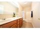 Well-lit bathroom featuring a double sink vanity with ample storage and a shower with a stylish polka dot curtain at 1502 Heron Ridge Blvd, Greenwood, IN 46143