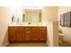 Bathroom featuring double sinks, wooden cabinetry, and neutral paint at 1502 Heron Ridge Blvd, Greenwood, IN 46143