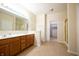 Bright bathroom featuring a double vanity, a large mirror, and a walk-in closet at 1502 Heron Ridge Blvd, Greenwood, IN 46143