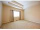 Bright bedroom featuring a tray ceiling, plush carpet, and large window at 1502 Heron Ridge Blvd, Greenwood, IN 46143