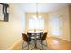 Cozy dining room with a round table, four chairs, and a window providing natural light at 1502 Heron Ridge Blvd, Greenwood, IN 46143