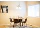 Dining room with round table, seating for four, under a decorative chandelier and rug at 1502 Heron Ridge Blvd, Greenwood, IN 46143