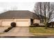 Charming brick townhouse with two-car garage and manicured landscaping at 1502 Heron Ridge Blvd, Greenwood, IN 46143