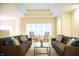 Bright living room featuring two couches, plush pillows, modern decor, and a tray ceiling at 1502 Heron Ridge Blvd, Greenwood, IN 46143