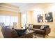 Contemporary living room featuring gray sofas, artwork, plush pillows, and a glass top table at 1502 Heron Ridge Blvd, Greenwood, IN 46143