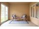Inviting patio featuring two chairs with decorative pillows on a stylish rug, perfect for relaxing outdoors at 1502 Heron Ridge Blvd, Greenwood, IN 46143