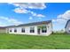Spacious backyard featuring a covered patio and lush green lawn, ideal for outdoor enjoyment at 1627 Clover Crossing Dr, Greenfield, IN 46140