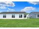 Spacious backyard featuring a lush green lawn and a view of other homes at 1627 Clover Crossing Dr, Greenfield, IN 46140