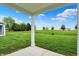 Picturesque view from the covered patio onto the expansive green backyard at 1627 Clover Crossing Dr, Greenfield, IN 46140