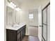 Bright bathroom with double vanity sinks and a view into a bedroom and shower at 1627 Clover Crossing Dr, Greenfield, IN 46140