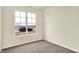 This bedroom has neutral carpet and paint and a large window for lots of natural light at 1627 Clover Crossing Dr, Greenfield, IN 46140