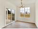 Bright dining area featuring sliding glass doors to the patio and a modern chandelier above at 1627 Clover Crossing Dr, Greenfield, IN 46140