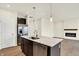 Bright kitchen with island, stainless steel appliances, and open layout to living room with fireplace at 1627 Clover Crossing Dr, Greenfield, IN 46140