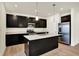Modern kitchen featuring dark cabinetry, stainless steel appliances, and a spacious center island with pendant lighting at 1627 Clover Crossing Dr, Greenfield, IN 46140