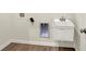 Laundry room with utility sink and hookups, and light-colored wood-look floors at 1627 Clover Crossing Dr, Greenfield, IN 46140