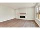 Spacious living room features hardwood floors, fireplace, and large window for natural light at 1627 Clover Crossing Dr, Greenfield, IN 46140