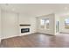 Bright living room featuring hardwood floors, fireplace, and large windows offering plenty of natural light at 1627 Clover Crossing Dr, Greenfield, IN 46140