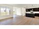 Open floor plan showcasing the kitchen with island and dark cabinets flowing into the dining area at 1627 Clover Crossing Dr, Greenfield, IN 46140