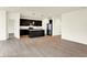 Open floor plan showcases the modern kitchen with island and dark cabinets, flowing into the living area at 1627 Clover Crossing Dr, Greenfield, IN 46140