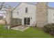 Charming backyard with stone chimneys, siding, sliding glass doors, and a cozy concrete patio at 2619 Chaseway Ct, Indianapolis, IN 46268