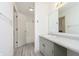 Bright bathroom features a neutral vanity with a large mirror, complemented by light gray flooring and tiled shower at 2619 Chaseway Ct, Indianapolis, IN 46268
