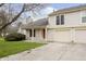 Charming two-story home with a well-manicured lawn, attached garages, and red front door at 2619 Chaseway Ct, Indianapolis, IN 46268