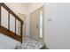 Bright foyer featuring tile flooring, staircase, and front door with sidelight at 2619 Chaseway Ct, Indianapolis, IN 46268