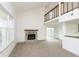 Spacious living room with vaulted ceiling, stone fireplace, and sliding glass doors to backyard at 2619 Chaseway Ct, Indianapolis, IN 46268