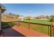 Back deck overlooking spacious backyard with a playground set, perfect for outdoor activities and Gathering fun at 2838 Violet W Ct, Columbus, IN 47201