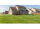 Well-maintained backyard with a deck, lawn, and play set, providing a perfect space for relaxation and recreation at 2838 Violet W Ct, Columbus, IN 47201