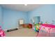 Bright blue playroom with a carpeted floor, toys, and mirrored wall at 2838 Violet W Ct, Columbus, IN 47201