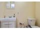 Neutral half bathroom featuring a vanity, mirror, toilet, and soap dispenser, perfect for guests at 2838 Violet W Ct, Columbus, IN 47201