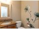 Stylish half-bathroom featuring a granite vanity, decorative wall art, and modern fixtures at 2838 Violet W Ct, Columbus, IN 47201