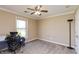 Bedroom featuring a ceiling fan, carpeted floor, and a large window at 2838 Violet W Ct, Columbus, IN 47201