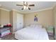 Bedroom featuring a comfortable bed, ceiling fan, neutral walls, and double-door closet at 2838 Violet W Ct, Columbus, IN 47201