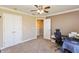 Bright bedroom with neutral walls, ceiling fan, and an open doorway to the hallway at 2838 Violet W Ct, Columbus, IN 47201