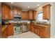 Gourmet kitchen featuring stainless steel appliances, tile backsplash, and custom cabinetry at 2838 Violet W Ct, Columbus, IN 47201